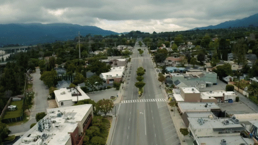 GIF montage of an open road, a city road with people biking, and a man flipping the open sign of a business