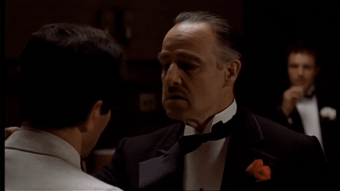 Iconic Godfather scene GIF with caption "I'm gonna make him an offer he can't refuse"